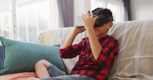 Happy Asian Boy Home Sitting Couch Living Room Wearing Headset — Stock Video