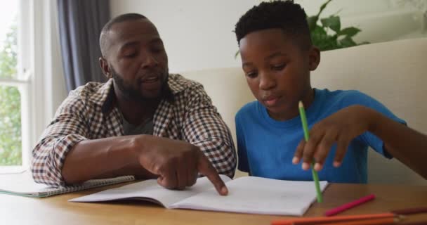 Happy African American Father Sitting Kitchen Table Helping Son School — Stock Video