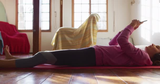 Glad Blandras Kvinna Hörlurar Liggande Yogamatta Med Smartphone Och Leende — Stockvideo