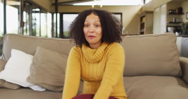 Happy Mixed Race Woman Sitting Couch Living Room Waving Smiling — Stock Video