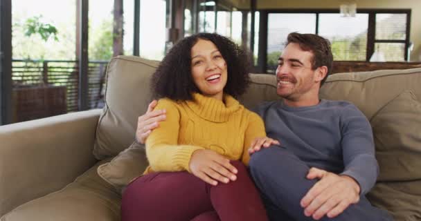 Retrato Feliz Pareja Diversa Sentada Sofá Sala Estar Abrazando Riendo — Vídeos de Stock