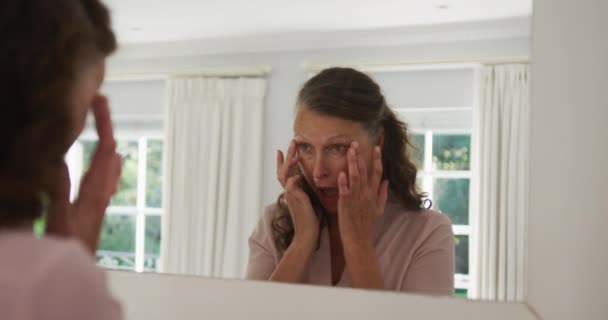 Senior Mujer Caucásica Pie Habitación Soleada Mirando Espejo Verificación Tocando — Vídeos de Stock