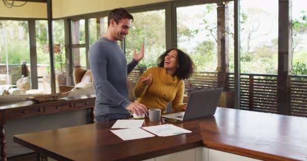 Diverse Couple Talking Living Room Using Laptop Looking Paperwork Paying — Stock Video