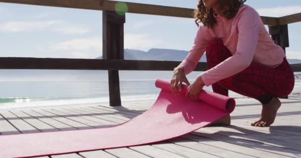 Healthy Mixed Race Woman Practicing Yoga Outdoors Squatting Rolling Mat — Stock Video