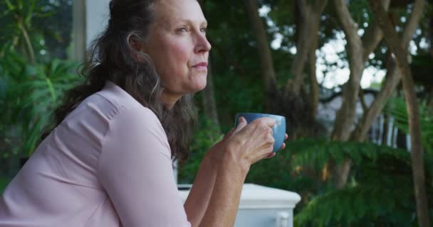 Nachdenkliche Seniorin Die Auf Der Terrasse Steht Kaffee Trinkt Und — Stockvideo