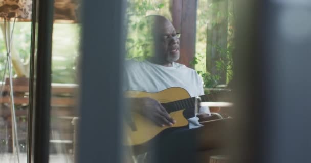 Düşünceli Afrikalı Amerikalı Son Sınıf Öğrencisi Balkonda Oturmuş Akustik Gitar — Stok video