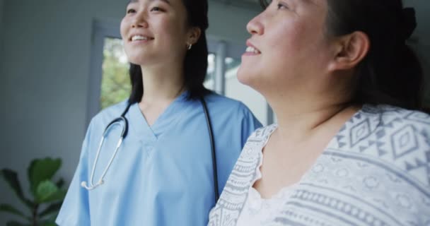 Smiling Asian Female Doctor Helping Happy Female Patient Walk Walking — Stock Video