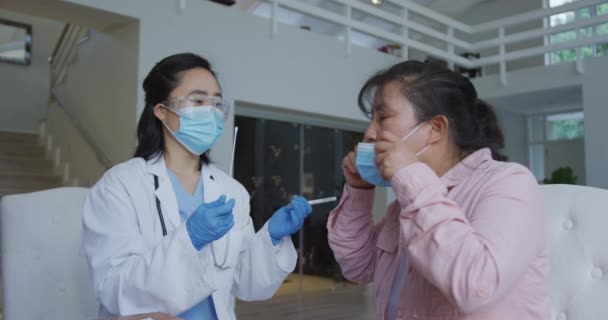 Asian Female Nurse Wearing Face Mask Giving Covid Swab Test — Stock Video