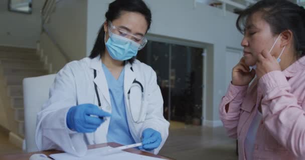 Asian Female Nurse Wearing Face Mask Gloves Writing Consultation Female — Stock Video