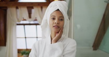 Kameraya bakan bornoz giymiş melez bir kadının portresi. ev hayatı, kaliteli boş zaman geçirmek evde dinlenmek..