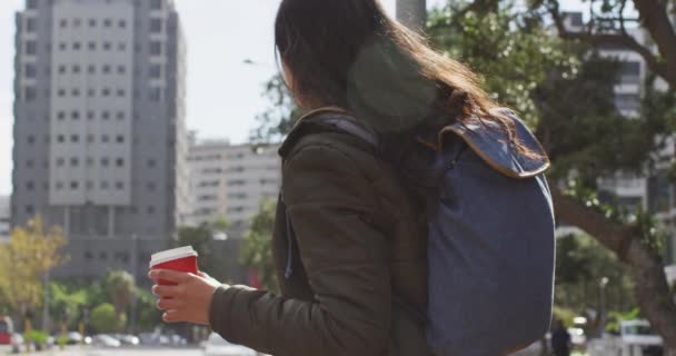 Asian Woman Holding Coffee Cup Talking Smartphone While Standing Street — Stock Video