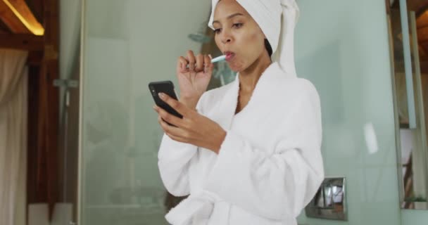 Μικτή Φυλετική Γυναίκα Βούρτσισμα Δοντιών Χρησιμοποιώντας Smartphone Οικιακή Ζωή Ξοδεύοντας — Αρχείο Βίντεο
