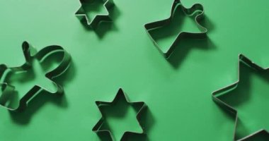 Angel, zencefilli kurabiye adam ve yıldız şeklinde kurabiye kesiciler ve yeşil arka planda fotokopi alanı. Noel, gelenek ve kutlama konsepti videosu.