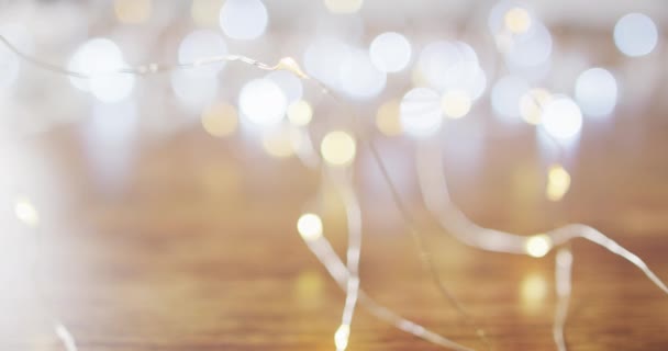 Video Lit Fairy Lights Christmas Decorations Bokeh Lights Wooden Background — Stock Video