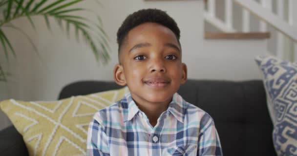 African American Boy Siting Sofa Looking Camera Smiling Childhood Leisure — Stock Video