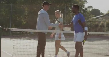 Çeşitli tenis antrenörleri ve oyuncular el sıkışıyor, teçhizat boşaltmaya başlıyor ve sahadan yedek kulübesine geçiyor. Atletik, takım çalışması, doğal, canlı, rekabetçi, aktif, ortaklık