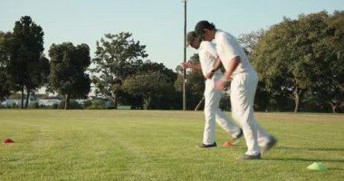 Kırmızı yeşil koniler arasında diz üstü matkabı bitirmek üzere farklı ortaklar ayak yerleştirme geri bildirimi yapıyor. Sporcular, antrenman, koordinasyon, spor, egzersiz, takım çalışması, açık hava