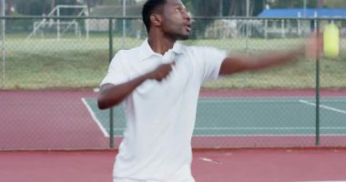 Top atma servisini başlatan çeşitli erkek oyuncular tenis kortunda oynayıp ağda el sıkışıyor. Sportmenlik, rekabet, atletizm, açık hava, takım çalışması, canlılık, aktivite kıyafeti