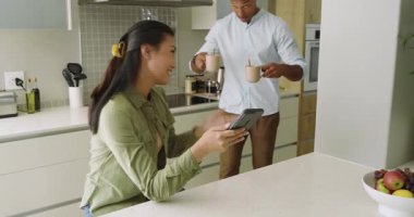 Omzunun üzerinden el hareketleriyle çeşitli çiftler, adada tabletin yanındaki bardaklara su döküyorlar. Yurt içi, samimiyet, modern, yaşam tarzı, sıcak, neşeli, bağlantı