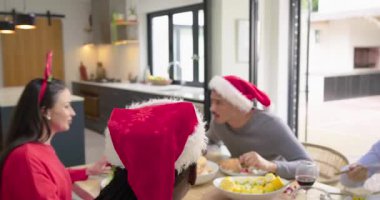 Çeşitli arkadaşlar mum uzatıyor, kadeh kaldırıyor, yemek masasında salata ve sebze yiyor. Kutlama, dostluk, neşe, tatil, neşe, sıcaklık, birliktelik.