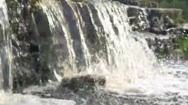 Şelale, nehirden akan su. Kahverengi renkli, fırtınalı bir nehir..
