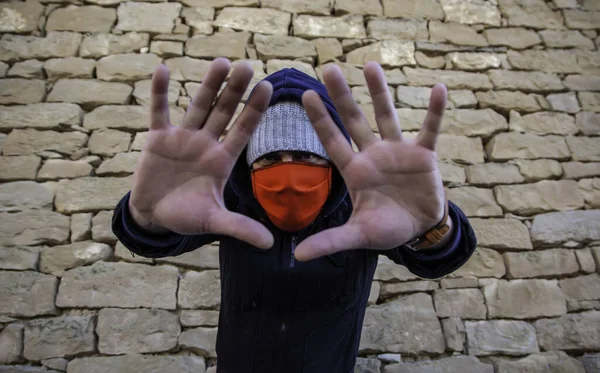 Young street gang with mask in park, social problem