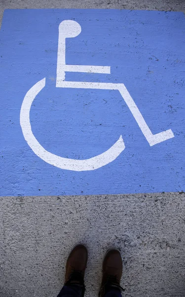 Sign detail for disabled people, feet of person