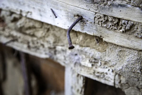 Rusty nail in broken wood, construction and architecture, texture