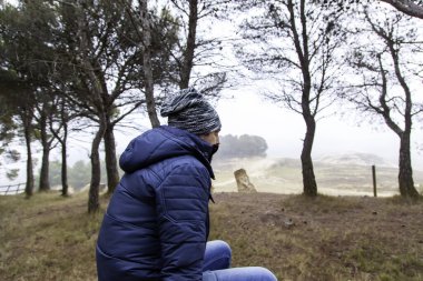 Şapkası ve maskesi, depresyonu ve yalnızlığı olan dalgın bir adam.