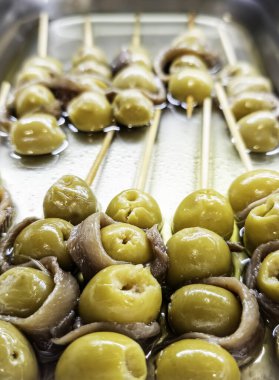 Detail of cured anchovy with green olives