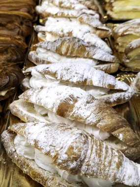 Detail of a butter croissant filled with whipped cream