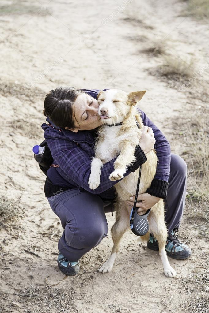 Woman kissing dog