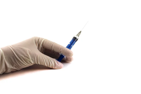 The doctor's hand in glove holding a syringe. Isolated object on Stock Photo