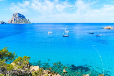 Güzel mavi deniz suyuyla Cala d 'Hort Körfezi manzarası ve İbiza Adası, İspanya' da Es Vedra adası.