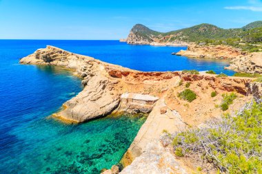 Punta Galera Körfezi 'ndeki kayıkhaneler İbiza Adası, İspanya' daki inanılmaz taş oluşumlarıyla çevrili.