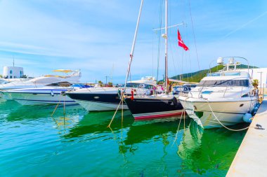 Lüks motor ve yelkenli tekneleri Santa Eularia limanında, İbiza adasında demirliyor.