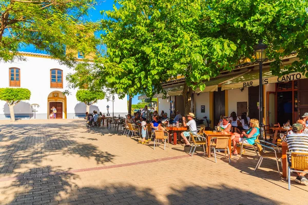 SANTA GERTRUDIS DE FRUTERA, IBIZA ADASI - 19 Mayıs 2017: İspanya 'nın İbiza adasındaki Santa Getrudis kasabasındaki kilise meydanındaki restoranlarda oturan insanlar.