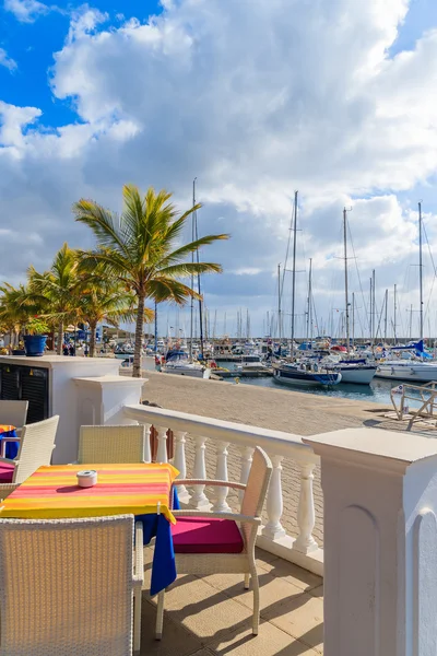 Table with chairs in restaurant in Puerto Calero marina — Φωτογραφία Αρχείου