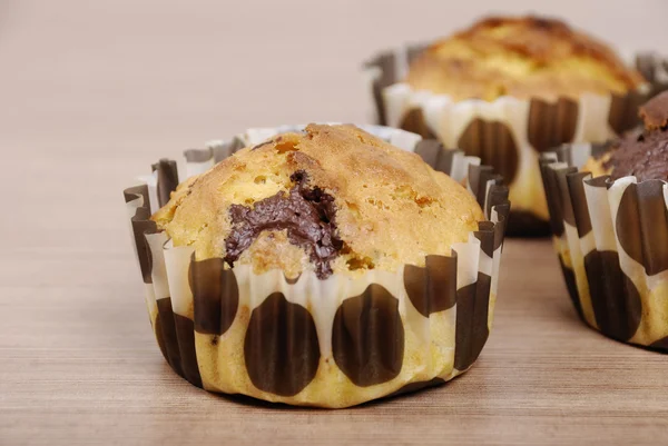 Homemade cupcakes with chocolate on a wooden table — Stock Photo, Image