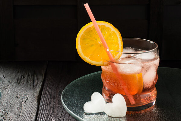 Aperol cocktail with orange slices and ice 