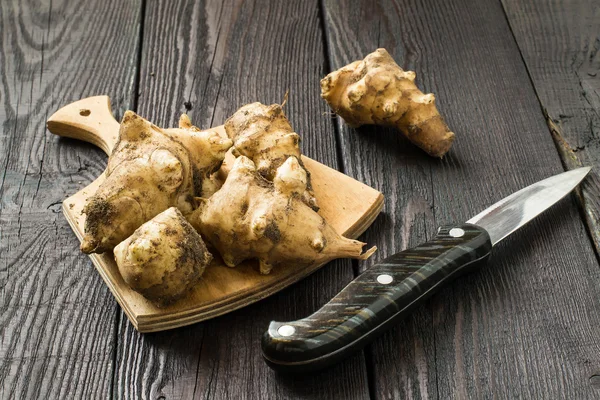 Fresh jerusalem artichokes on the board — Stock Photo, Image