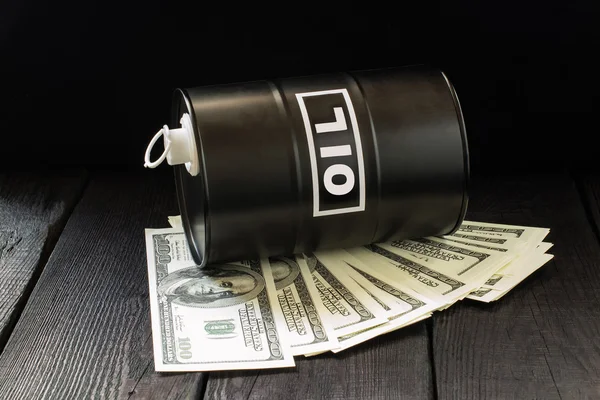Oil business concept. Barrel of oil on dollar bills