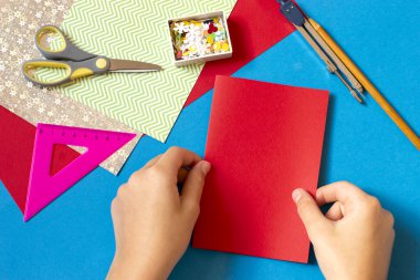 Making Christmas card with voluminous tree. Original project for children. DIY concept. Step-by-step photo instructions. Step 2. Fold paper sheet in half for base of postcard 