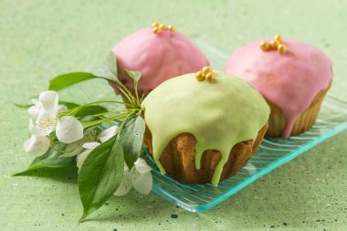 Colored cupcakes and flowers of apple 