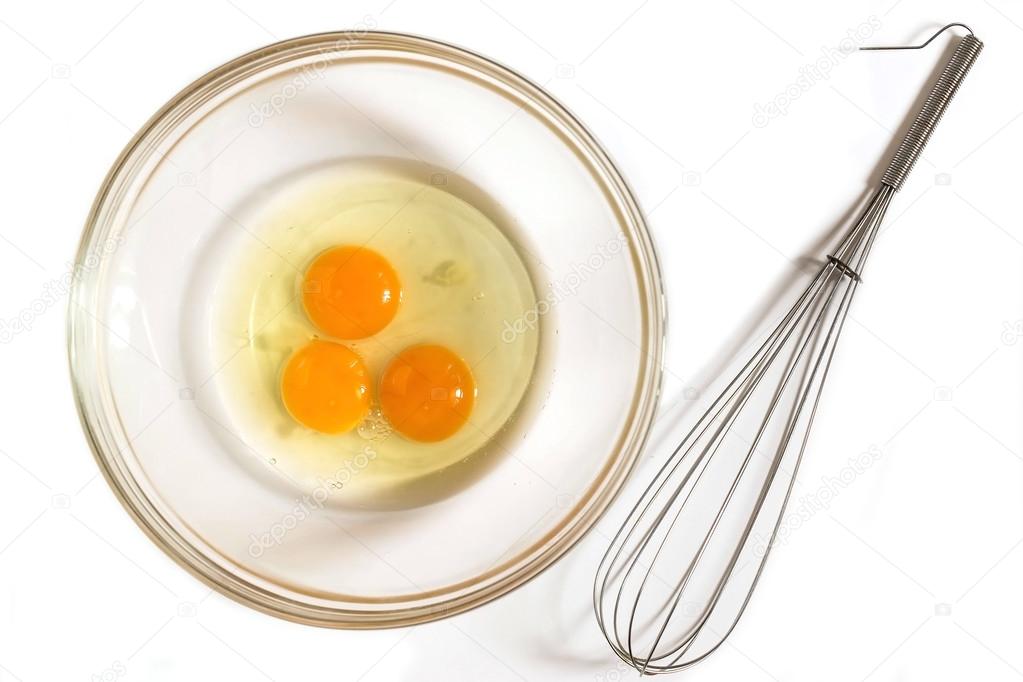 Three eggs in a bowl and whisk for whipping 