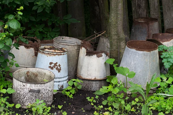 The old leaky bucket near the fence — Stock Photo, Image