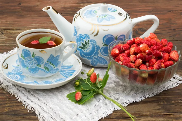 Strawberry tea in a pot with a national ornament
