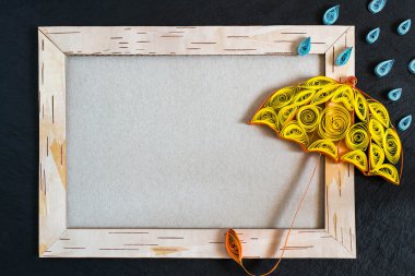 Frame from birch bark, umbrella and rain drops in the technique 