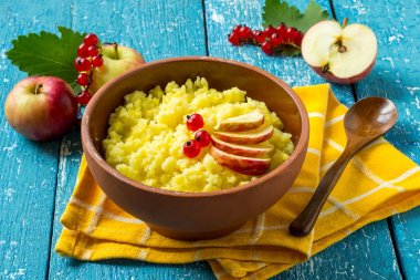 Useful millet porridge with apple and red currant  clipart