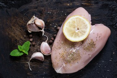 Chicken breast, garlic, lemon and herbs - ingredients for cookin